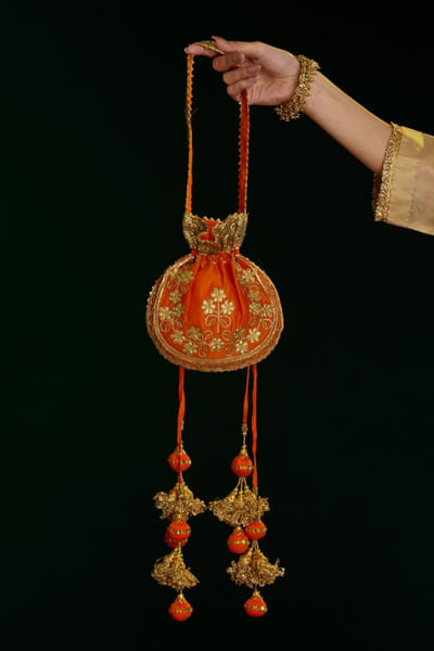 Deep orange aari embroidered potli bag