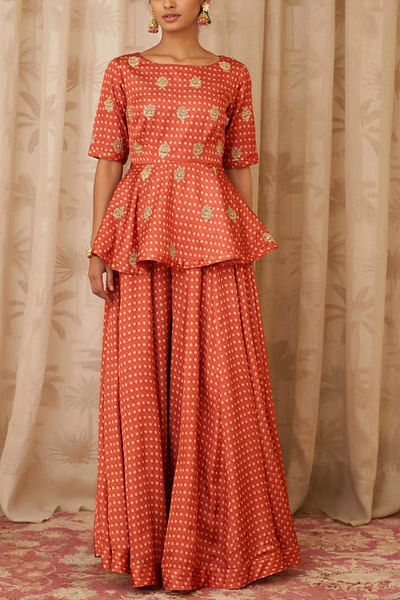 Rust orange peplum and flared trousers