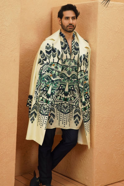 Ivory geometry-tribal mask printed trench coat
