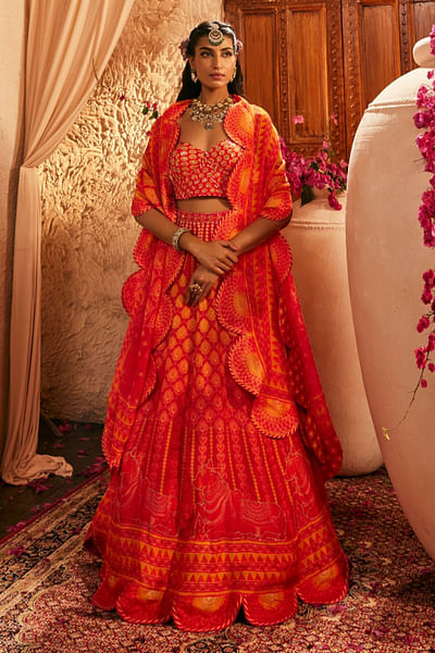 Red and orange cow printed lehenga set