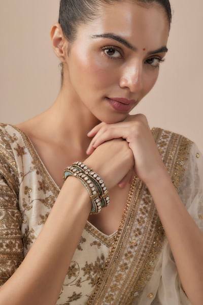 Gold and green stone-enamel bangles