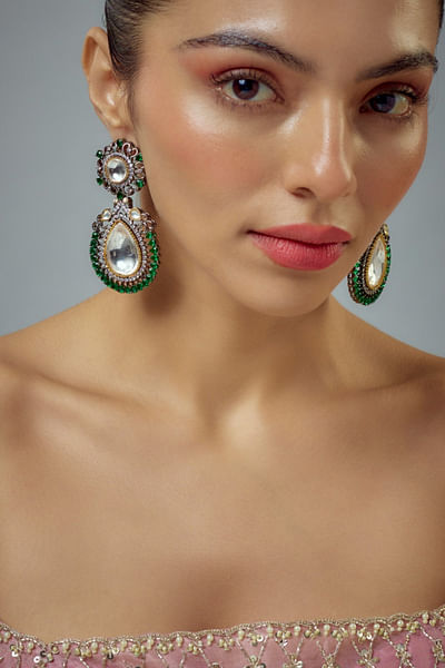 Silver kundan green stone embellished earrings