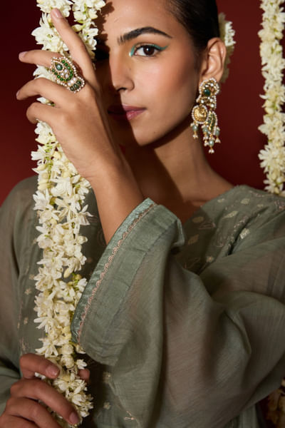 Green and white embellished ring