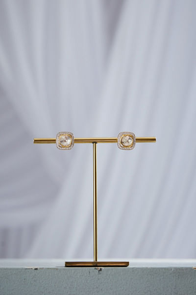White and gold stud earrings